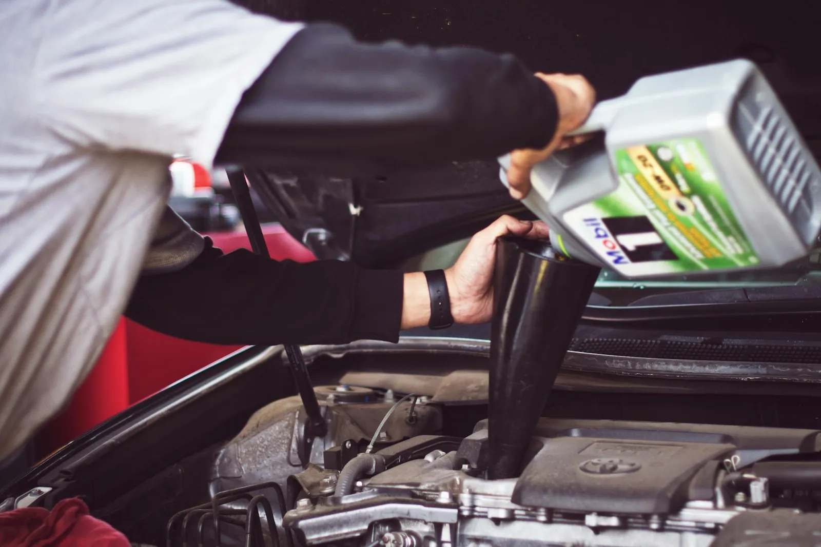 Technician working on an engine at 5 Points Automotive